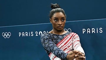 US' Simone Biles looks on during the artistic gymnastics women's team final during the Paris 2024 Olympic Games at the Bercy Arena in Paris, on July 30, 2024. (Photo by Lionel BONAVENTURE / AFP)