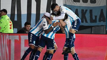Racing's midfielder Axel Ojeda (Covered) celebrates with teammates after scoring a goal during the Copa Libertadores round of 16 second leg football match between Argentina's Racing Club and Colombia's Atletico Nacional, at the Presidente Juan Domingo Peron (El Cilindro) stadium, in Buenos Aires, on August 10, 2023. (Photo by Luis ROBAYO / AFP)
